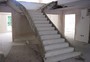 Curved concrete stairs with a concrete closed string, 3 metres high