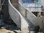 A curved concrete stairs, enteance steps with solid concrete balustrade