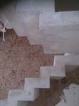 Built against a wall, this off whit, zigzag style stair is 1 metre wide