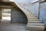 1 metre wide helical concrete stairs against a wall