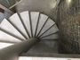 A spiral concrete stairs with concrete central column