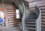A helical staircase with concrete balustrade