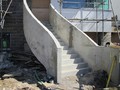 Helical concrete entrance steps with concrete balustrade